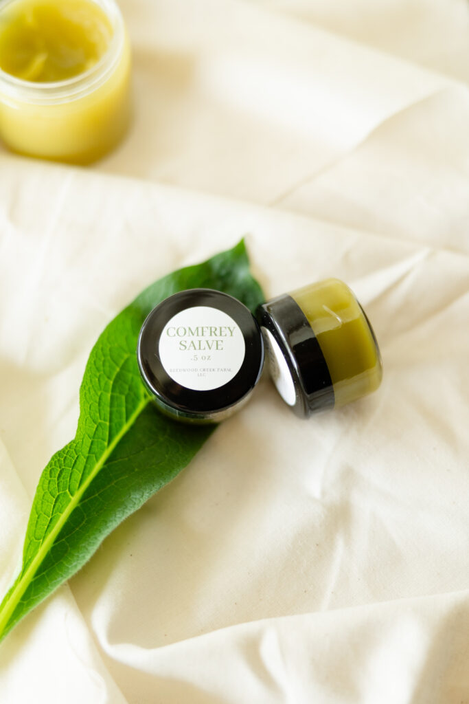 Comfrey salve with green leaf on white background
