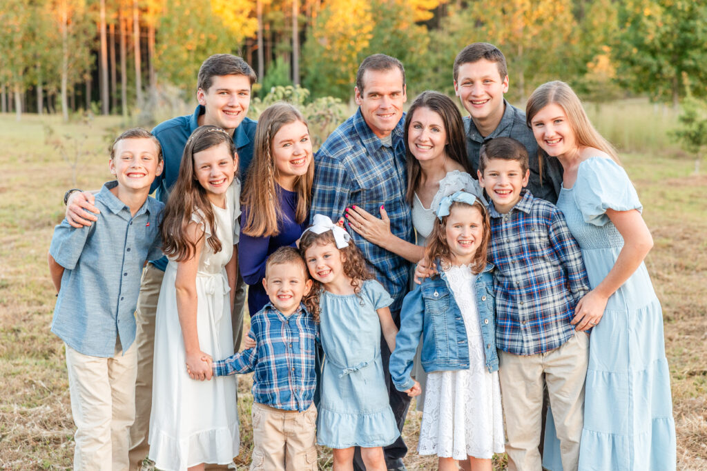 Big family hugs each other and smiles