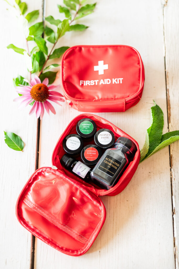 Red herbal first aid kit featuring herbal products and people's paste