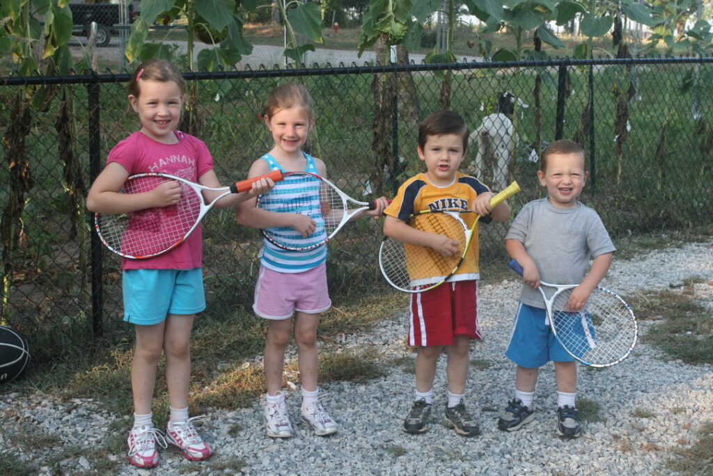 Four kids on a farm in the country