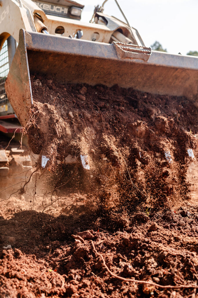 Skid steer moving dirt