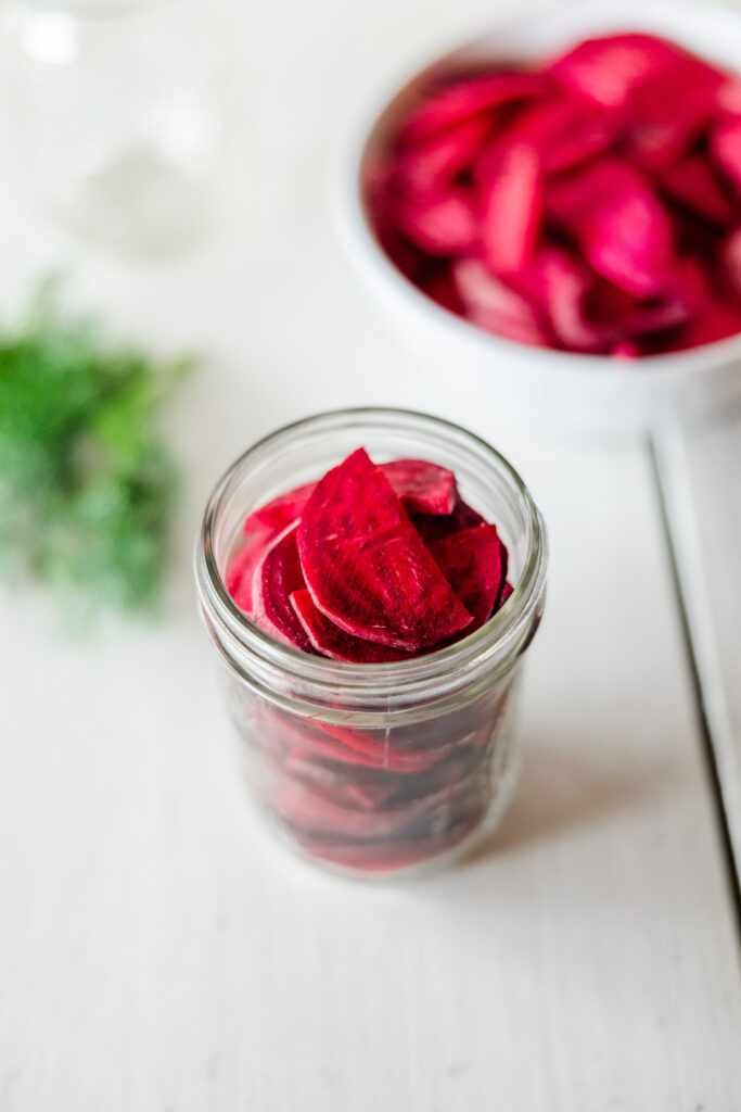 Thinly sliced beet vegetables in pickling jar